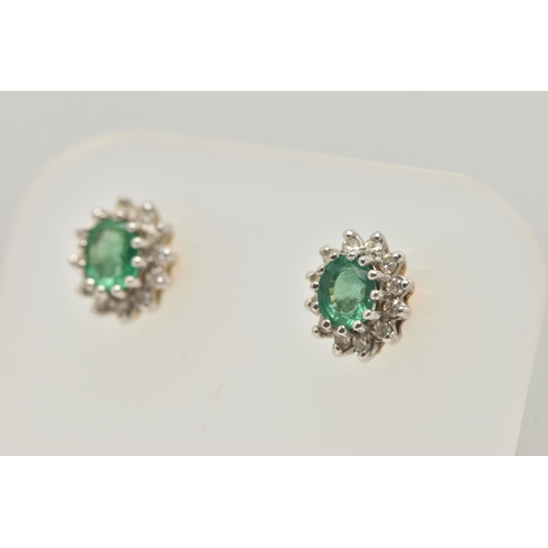 20 - A PAIR OF EMERALD AND DIAMOND EARRINGS AND A PENDANT, each earring designed as an oval cluster, set ... 