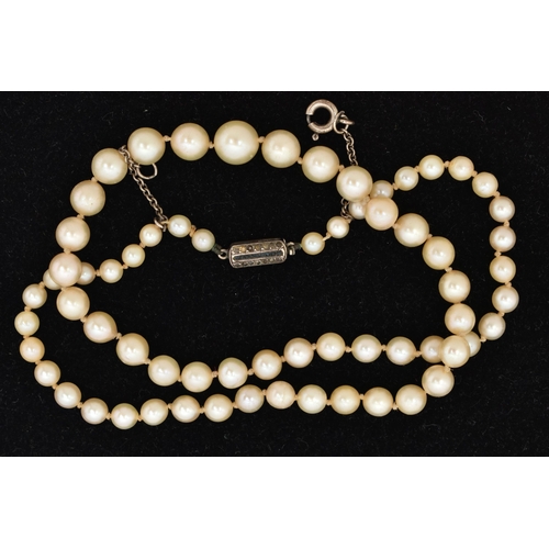 21 - A CULTURED PEARL NECKLACE, a single row of graduated cream pearls, individually knotted on a white c... 