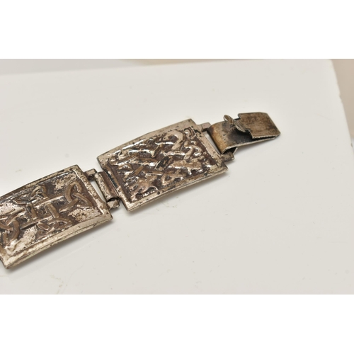 29 - A SILVER CELTIC ARTICULATED BRACELET, designed as a series of seven rectangular panels each with a C... 