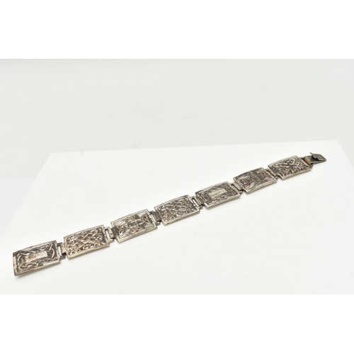 29 - A SILVER CELTIC ARTICULATED BRACELET, designed as a series of seven rectangular panels each with a C... 