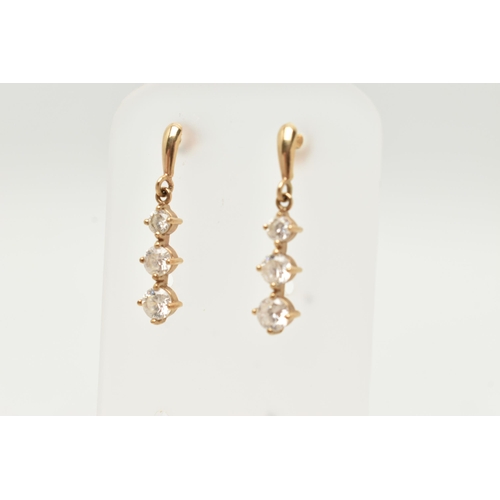 44 - A PAIR OF YELLOW METAL CUBIC ZIRCONIA DROP EARRINGS, designed as a row of three graduated colourless... 