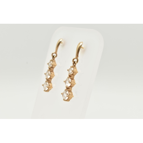 44 - A PAIR OF YELLOW METAL CUBIC ZIRCONIA DROP EARRINGS, designed as a row of three graduated colourless... 