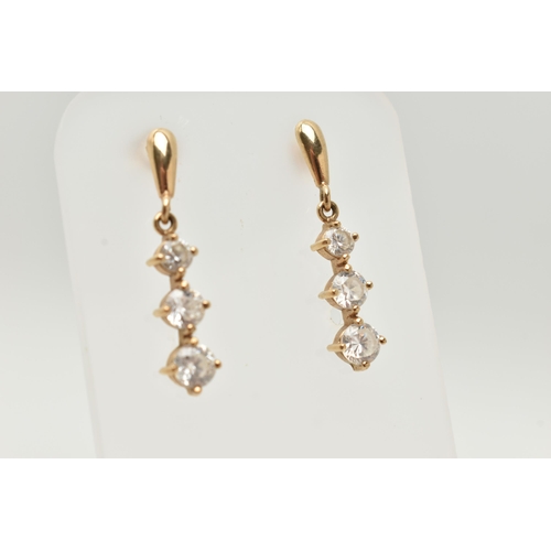 44 - A PAIR OF YELLOW METAL CUBIC ZIRCONIA DROP EARRINGS, designed as a row of three graduated colourless... 