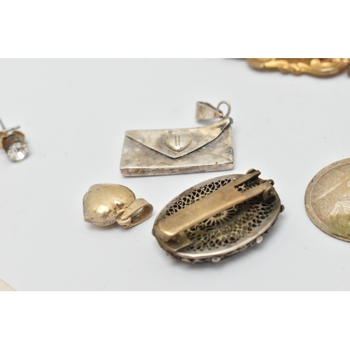 48 - A SMALL BAG OF JEWELLERY, to include a large carved cameo brooch, in a gilt metal mount, fitted with... 