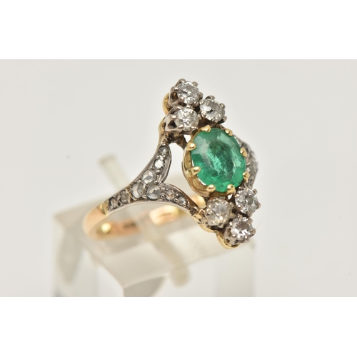 63 - AN 18CT GOLD EMERALD AND DIAMOND DRESS RING, centrally set with an oval cut emerald in an eight claw... 