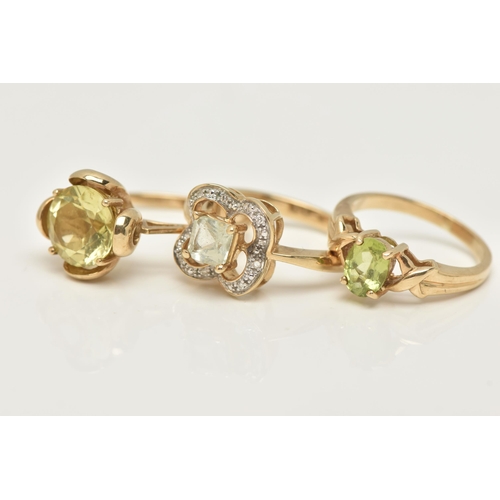 72 - THREE 9CT GOLD GEM SET RINGS, the first a circular cut citrine ring, ring size N, the second an oval... 