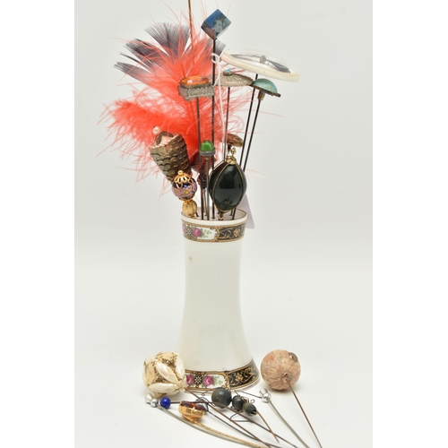 112 - A COLLECTION OF HAT PINS WITH STAND, various designs to the terminals, including a ceramic stand