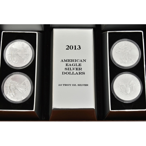 197 - A CASED DISPLAY OF USA SILVER DOLLAR COINS, to include Eagle Silver dollar coins  in individual boxe... 