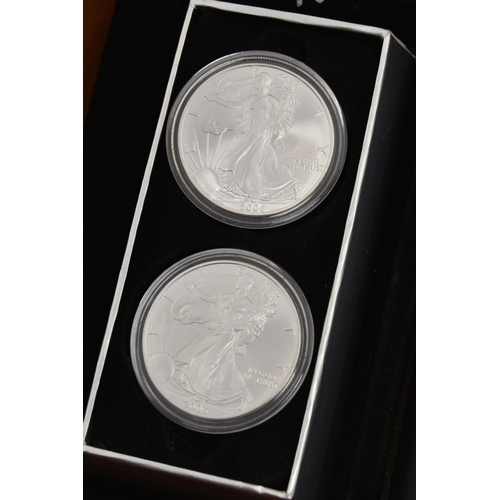 197 - A CASED DISPLAY OF USA SILVER DOLLAR COINS, to include Eagle Silver dollar coins  in individual boxe... 