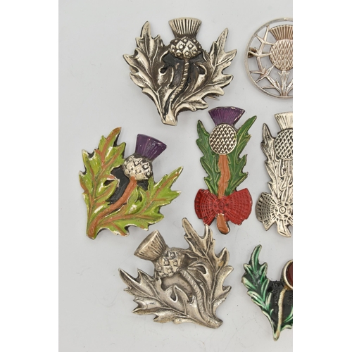 80 - A SELECTION OF MAINLY SCOTTISH RELATED JEWELLERY, to include various thistle brooches, some with ena... 