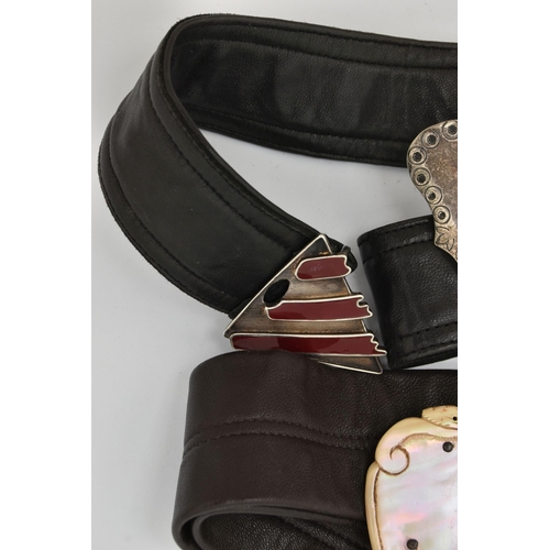 85 - BELTS AND BELT BUCKLES, to include two silver belt buckles on leather belts, an unmarked belt buckle... 