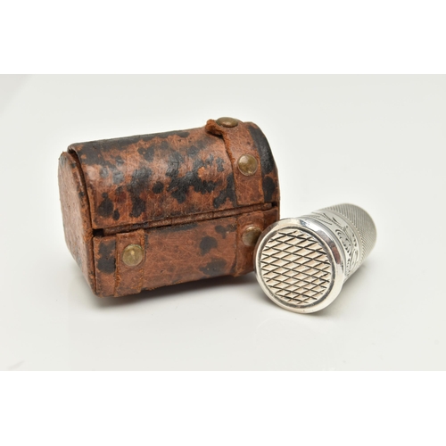 90 - A THIMBLE SCENT BOTTLE AND LEATHER CHEST CASE, the thimble with engraved foliate decoration, the bas... 