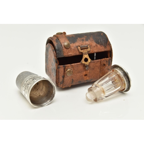 90 - A THIMBLE SCENT BOTTLE AND LEATHER CHEST CASE, the thimble with engraved foliate decoration, the bas... 