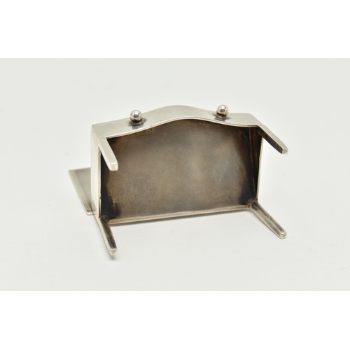 126 - AN EARLY 20TH CENTURY SILVER STAMP HOLDER, in the form of a miniature bow fronted desk, hinged cover... 