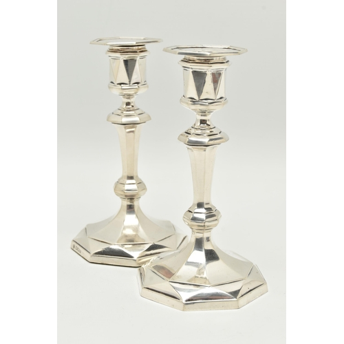 130 - A PAIR OF GEORGE V SILVER OCTAGONAL AND MULTI FACETED CANDLESTICKS RETAILED BY ASPREY, fixed sconce ... 