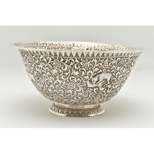 134 - A LATE 19TH/EARLY 20TH CENTURY INDIAN WHITE METAL BOWL, ornately repoussé decorated with foliate scr... 