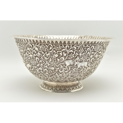 134 - A LATE 19TH/EARLY 20TH CENTURY INDIAN WHITE METAL BOWL, ornately repoussé decorated with foliate scr... 