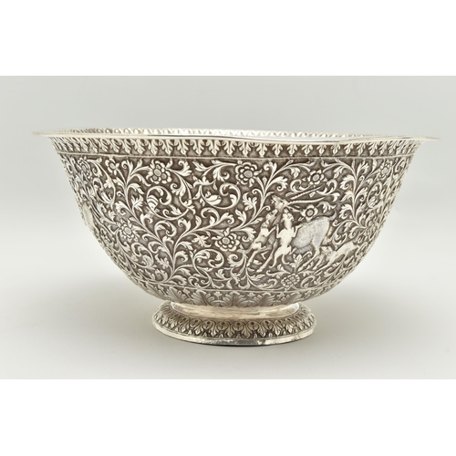 134 - A LATE 19TH/EARLY 20TH CENTURY INDIAN WHITE METAL BOWL, ornately repoussé decorated with foliate scr... 