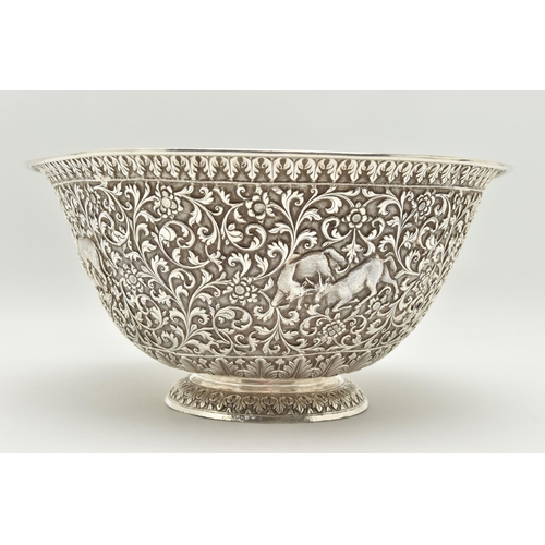 134 - A LATE 19TH/EARLY 20TH CENTURY INDIAN WHITE METAL BOWL, ornately repoussé decorated with foliate scr... 