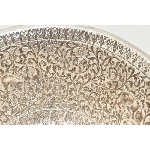 134 - A LATE 19TH/EARLY 20TH CENTURY INDIAN WHITE METAL BOWL, ornately repoussé decorated with foliate scr... 