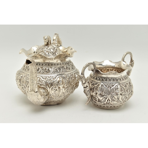 138 - AN INDIAN WHITE METAL TWO PIECE BACHELOR'S TEA SET, comprising teapot and twin handled sugar bowl, e... 