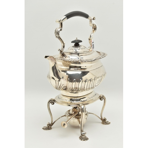 140 - A GEORGE V SILVER SPIRIT KETTLE ON STAND OF SHAPED RECTANGULAR FORM, of George IV style, foliate cas... 