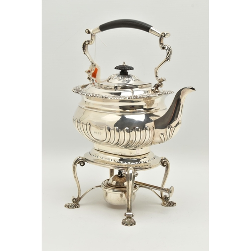 140 - A GEORGE V SILVER SPIRIT KETTLE ON STAND OF SHAPED RECTANGULAR FORM, of George IV style, foliate cas... 