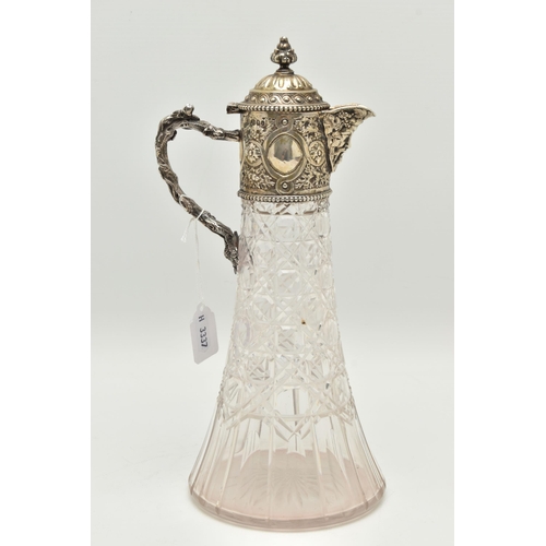 142 - A SILVER MOUNTED GLASS CLARET JUG, cut glass tapering jug with an embossed silver mounted hinged cov... 