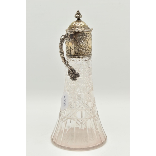 142 - A SILVER MOUNTED GLASS CLARET JUG, cut glass tapering jug with an embossed silver mounted hinged cov... 