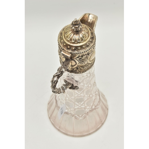 142 - A SILVER MOUNTED GLASS CLARET JUG, cut glass tapering jug with an embossed silver mounted hinged cov... 