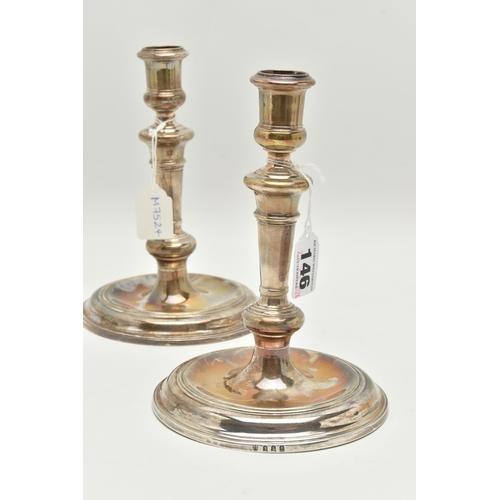 146 - A PAIR OF GEORGE V SILVER CANDLE STICKS, of 18th century style, tapering knopped stems, on a round b... 