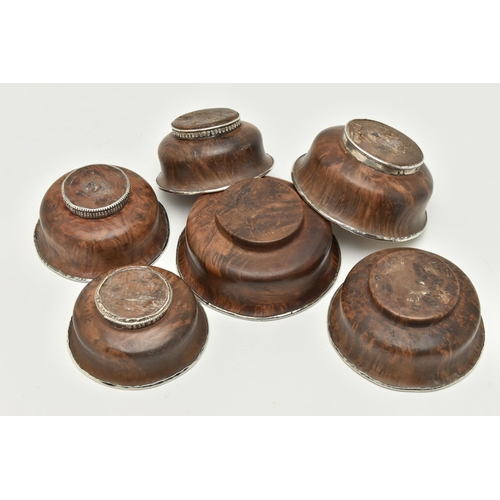 162 - SIX ASSORTED 19TH CENTURY TIBETAN WOODEN BOWLS WITH WHITE METAL LININGS/MOUNTS, largest diameter 12.... 