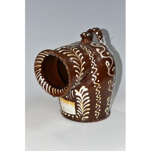 336 - A BROWN AND WHITE EARLY TWENTIETH CENTURY SLIPWARE SALT PIG, with trailed decoration, inscribed 'Dr.... 