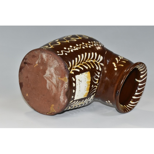 336 - A BROWN AND WHITE EARLY TWENTIETH CENTURY SLIPWARE SALT PIG, with trailed decoration, inscribed 'Dr.... 