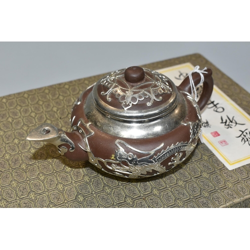 347 - A PRESENTATION BOXED SET OF CHINESE TEAWARE, comprising Chinese engraved pewter clad teapot, four cu... 