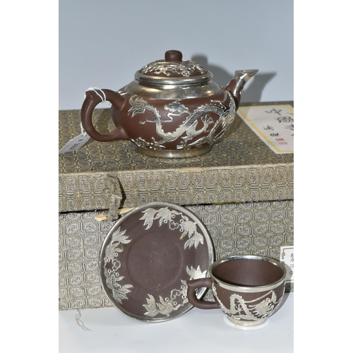 347 - A PRESENTATION BOXED SET OF CHINESE TEAWARE, comprising Chinese engraved pewter clad teapot, four cu... 