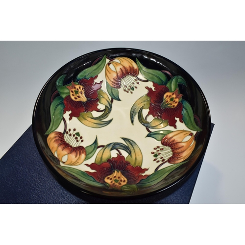 364 - A BOXED MOORCROFT POTTERY 'ANNA LILY' DESIGN BOWL, designed by Nicola Slaney, diameter 26cm (1) (Con... 