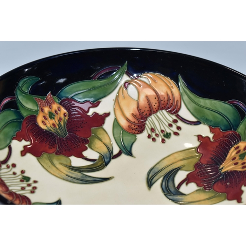 364 - A BOXED MOORCROFT POTTERY 'ANNA LILY' DESIGN BOWL, designed by Nicola Slaney, diameter 26cm (1) (Con... 