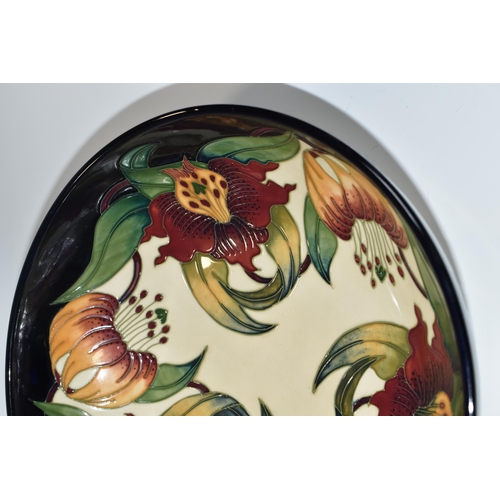 364 - A BOXED MOORCROFT POTTERY 'ANNA LILY' DESIGN BOWL, designed by Nicola Slaney, diameter 26cm (1) (Con... 