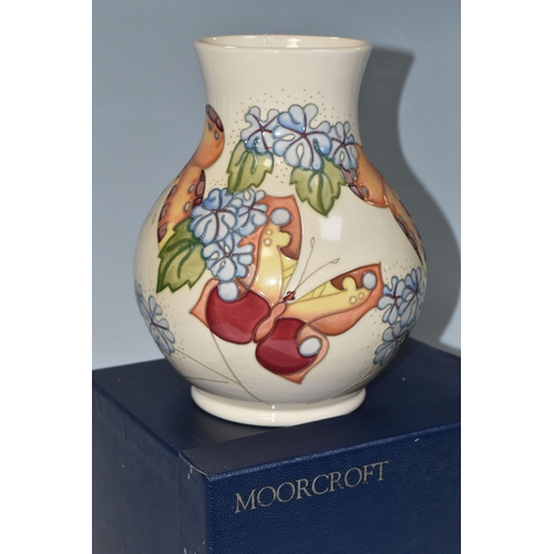 368 - A BOXED MOORCROFT POTTERY 'BUTTERFLY' PATTERN VASE, designed by Sally Tuffin, the baluster vase tube... 