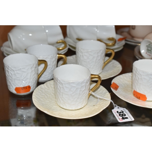 384 - A GROUP OF AYNSLEY AND COALPORT TEAWARE, comprising six white textured Coalport coffee cans with gil... 