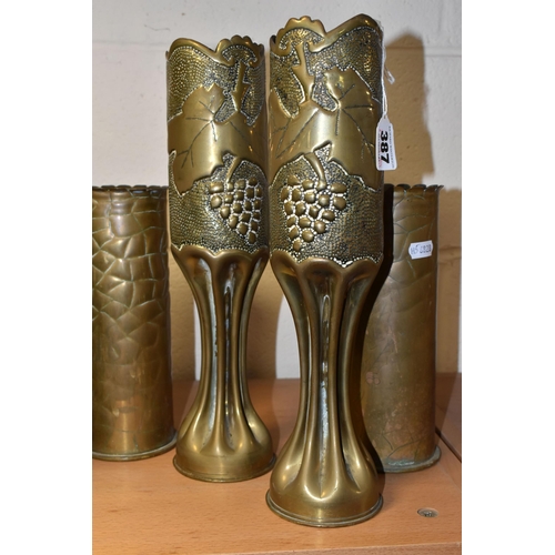 387 - TWO PAIRS OF TRENCH ART VASES, comprising two engraved with bunches of holly and the dates 1914 and ... 