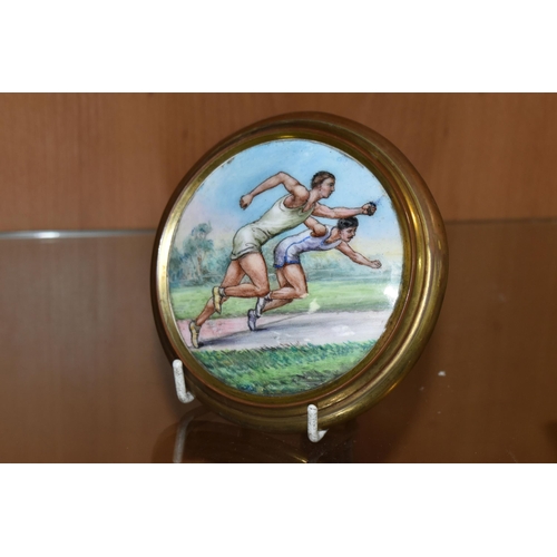 404 - AN EARLY 20TH CENTURY SPORTING  ENAMEL PLAQUE DEPICTING TWO MALE ATHLETES IN A SPRINT, brass coated ... 