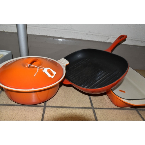 406 - THREE PIECES OF LE CREUSET CAST IRON COOKWARE, with trademark orange or red enamel finish, comprisin... 