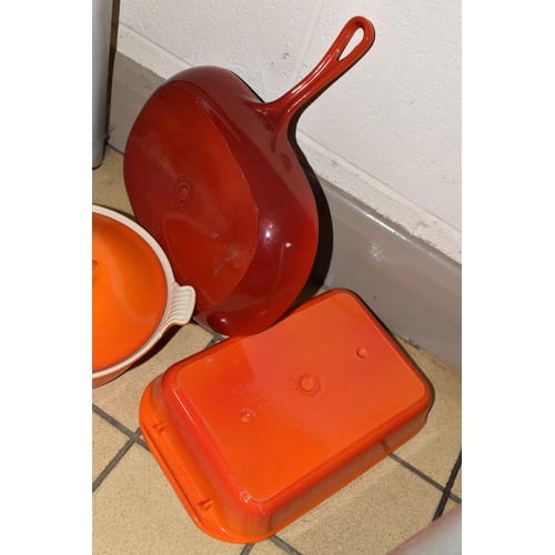 406 - THREE PIECES OF LE CREUSET CAST IRON COOKWARE, with trademark orange or red enamel finish, comprisin... 