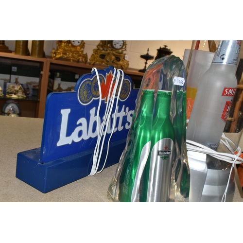 443 - FOUR PIECES OF BAR DECORATIONS to include a Labatt's light up sign with UK plug, a Heineken bottle i... 