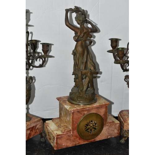 473 - A FRENCH ROSE MARBLE CLOCK GARNITURE, clock supporting a bronzed figure of a woman 'Rayon De Soleil'... 