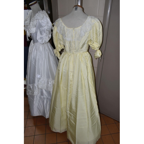 482 - A 1980S PRONUPTIA WHITE SATIN WEDDING DRESS AND LEMON AND WHITE STRIPED BRIDESMAID DRESS, comprising... 