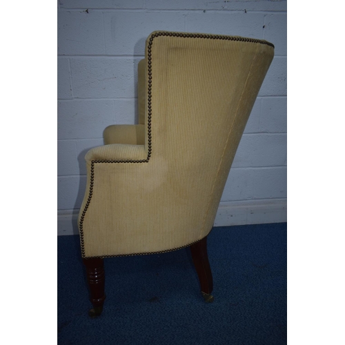 1348 - A REPRODUCTION BARRELL BACK ARMCHAIR, with beige stripped fabric, on turned front legs and brass cap... 