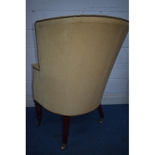 1348 - A REPRODUCTION BARRELL BACK ARMCHAIR, with beige stripped fabric, on turned front legs and brass cap... 